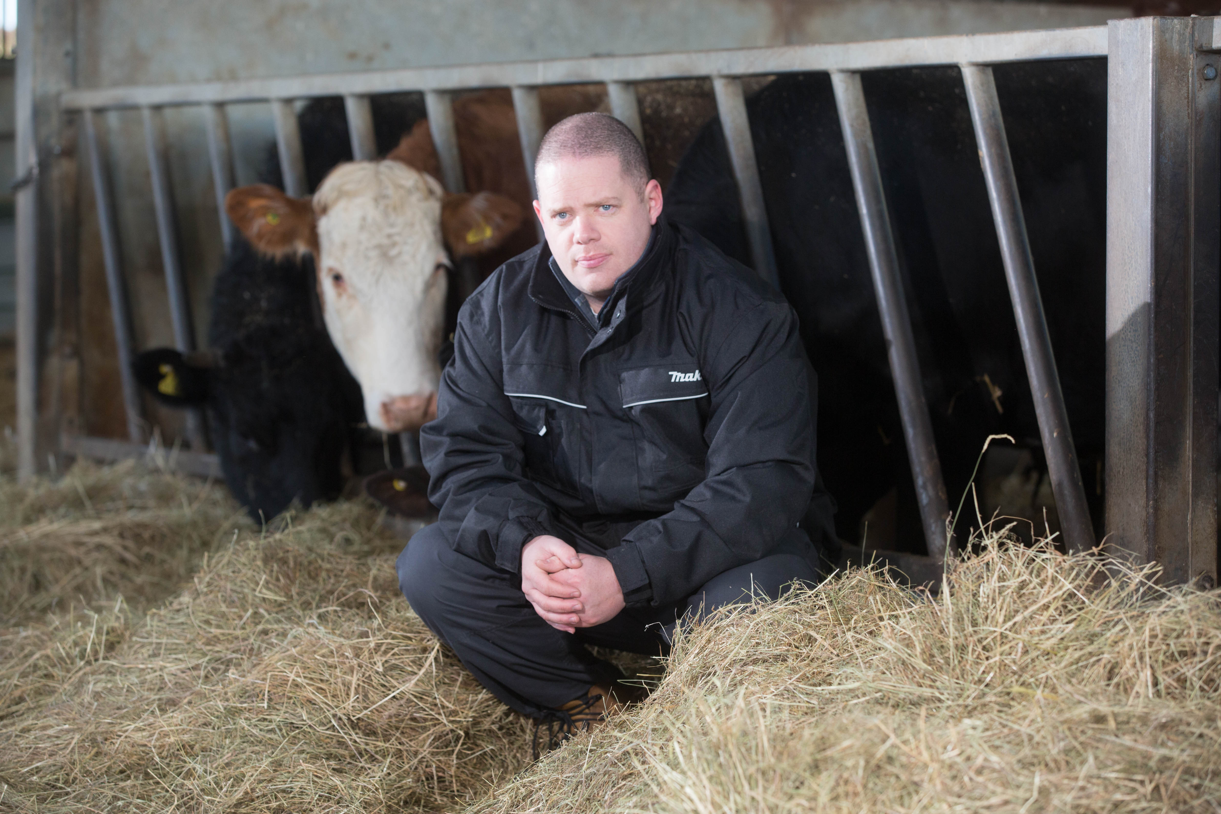 Strategic Farmer, Mark Jelley, with cows behind